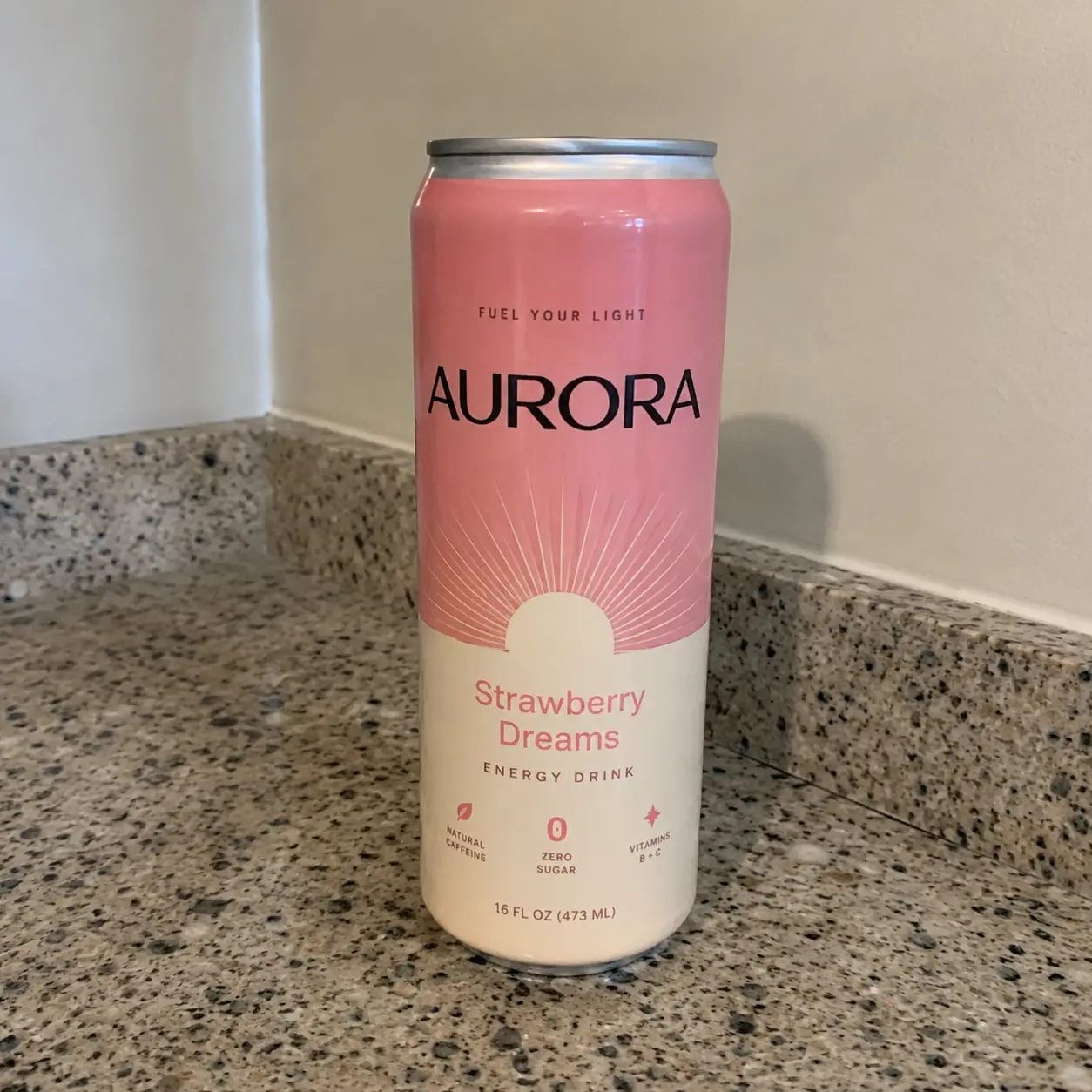 Phone photo of the Aurora Strawberry Dreams can on a speckled kitchen counter
