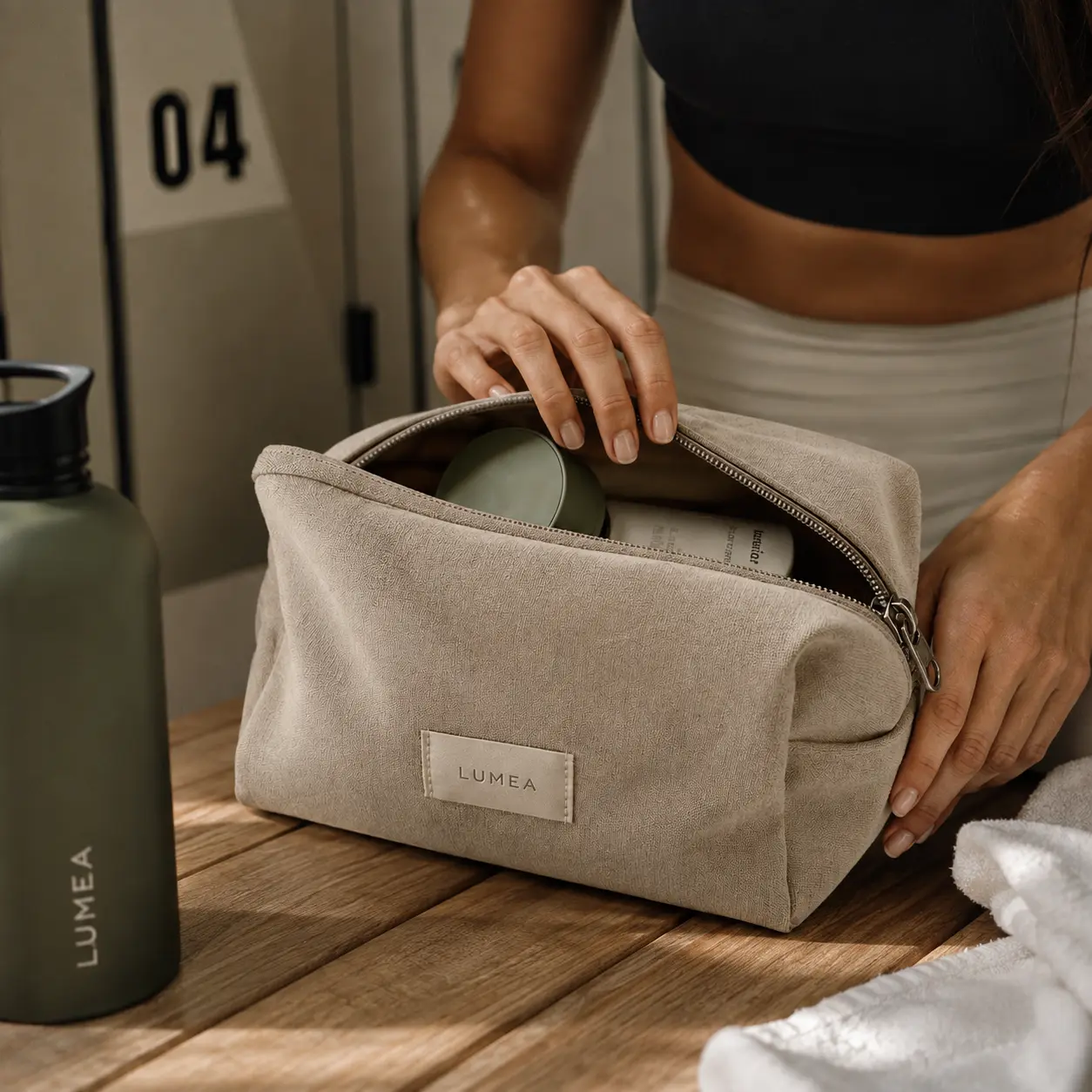 Campaign photo of the linen wash pouch on a locker room bench